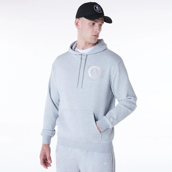 The Male model is wearing Brooklyn Nets NBA League Essential Grey Oversized Pullover Hoodie 4