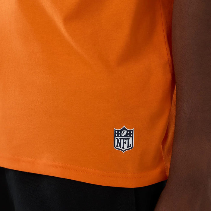 The Male model is wearing Denver Broncos NFL International Series Games 2025 Orange Oversized T-Shirt 5