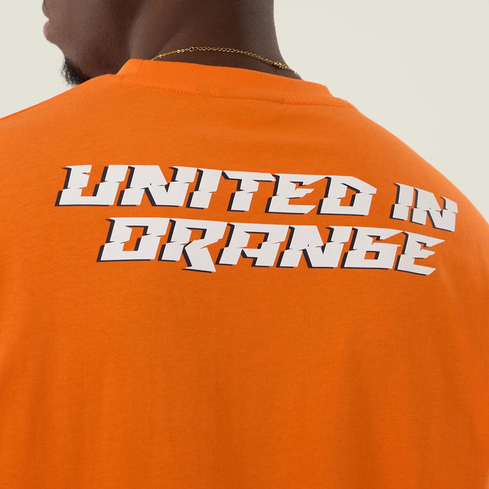The Male model is wearing Denver Broncos NFL International Series Games 2025 Orange Oversized T-Shirt 6