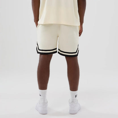 The model is wearing these NFL Historic Las Vegas Raiders shorts in cream. 2