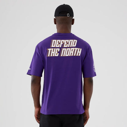 The Male model is wearing Minnesota Vikings NFL International Series Games 2025 Purple Oversized T-Shirt 2