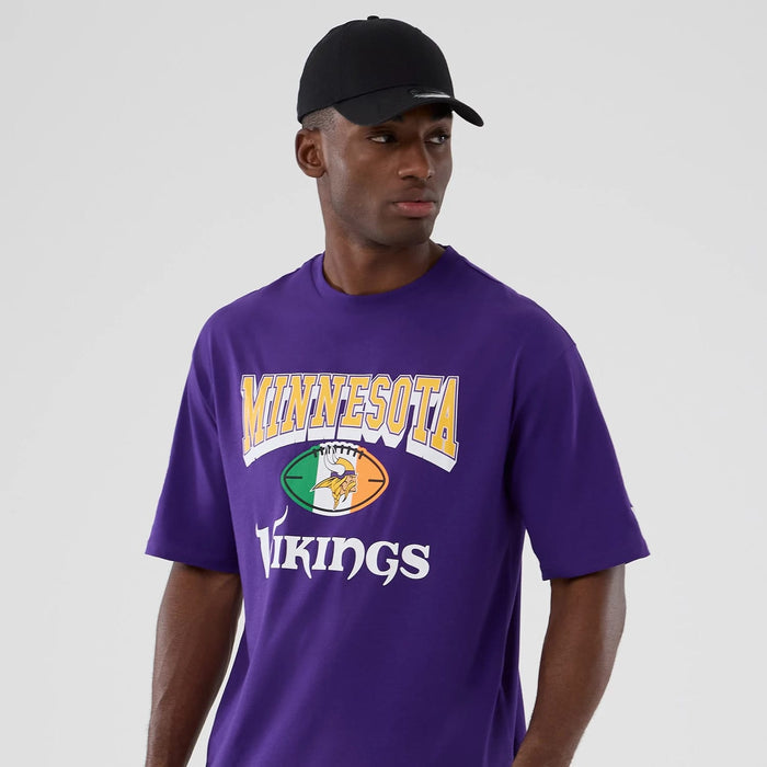 The Male model is wearing Minnesota Vikings NFL International Series Games 2025 Purple Oversized T-Shirt 3