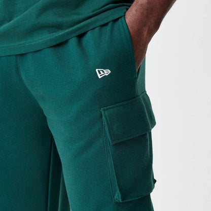 The Male model is wearing  New Era Core Cargo Dark Green Joggers 7