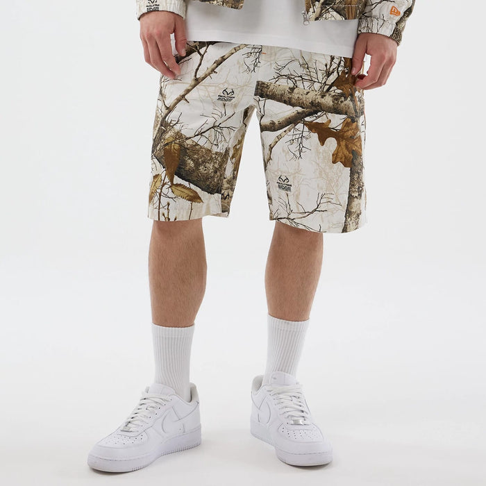 The Male model is wearing  New Era Earthy Skin Real Tree Snow Oversized Shorts 7