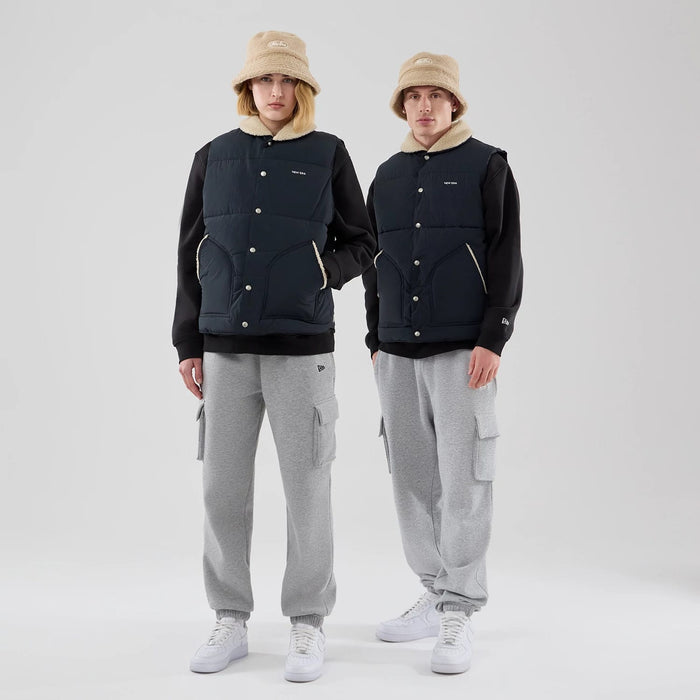 The Male model is wearing  New Era Organic Boa Neck Navy Gilet 1