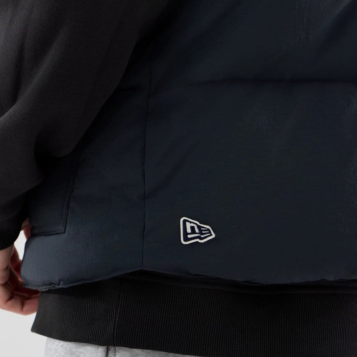 The Male model is wearing  New Era Organic Boa Neck Navy Gilet 7