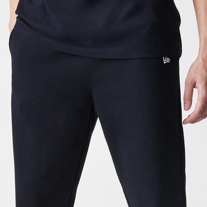 The Male model is wearing New Era Premium Essential Black Joggers 4