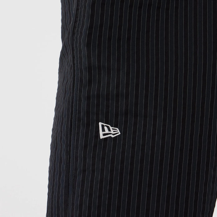 The model is wearing these New Era Street Class straight leg joggers in navy. 3