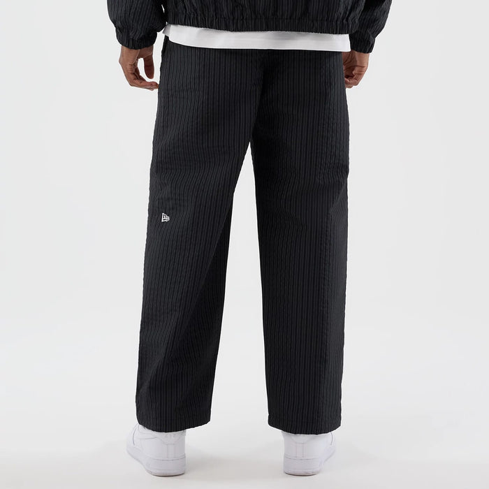The model is wearing these New Era Street Class straight leg joggers in navy. 6