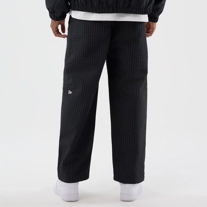 The model is wearing these New Era Street Class straight leg joggers in navy. 6