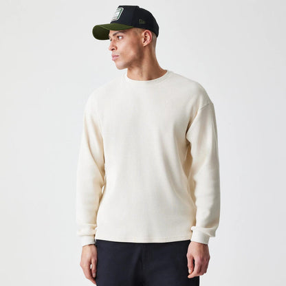 The Male model is wearing  New Era Waffle Light Beige Long Sleeve T-Shirt 1