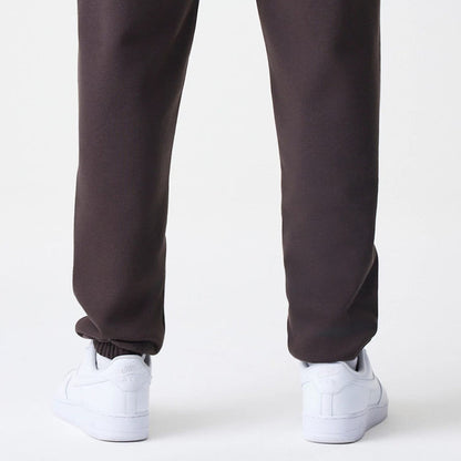 The Male model is wearing New York Yankees MLB Midi League Essential Dark Brown Joggers 4